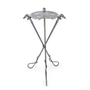 An antique, cast metal horse racing themed table, the legs…