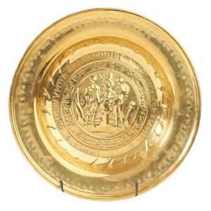 Two brass alms chargers, 17th century, each with embossed…