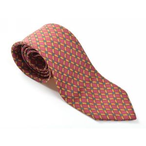A silk tie by Hermes, styled with a gold and green pattern on a&hellip;