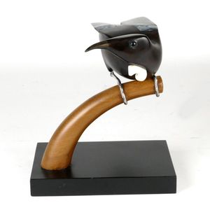 A Martin Carryer carved bird, the tui in black maire with paua…