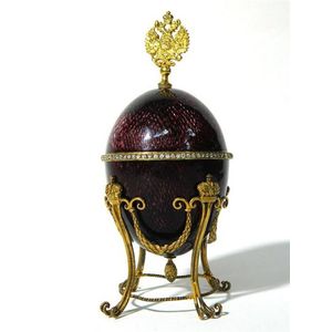 A guilloche enamel & gilt metal Faberge style egg, small loss…