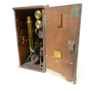 A 19th century gilt brass monocular microscope, with tripod…
