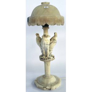A figural alabaster table lamp, early 20th century, carved with…