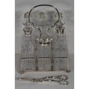 Silver plated and glass 6 bottle cruet set by Walter Oxley,…