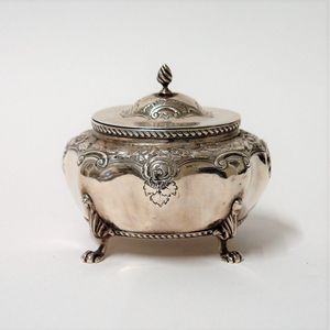 A late Victorian silver hinged lidded tea caddy, lobed ovoid…