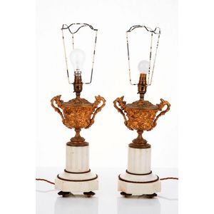 Pair of gilded metal and white marble table lamps, each cast as…