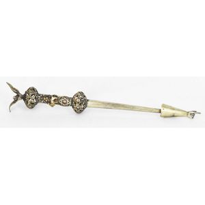 A silver torah yad, with eagle finial, lion and flower design.…