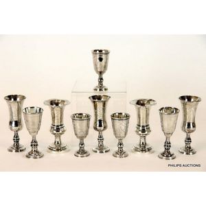 Eight sterling silver kiddush cups in three designs, two vases,…