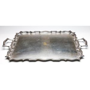 A large twin handled silverplated serving tray with etched…