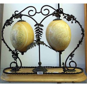 An Australian emu egg Centerpiece, comprising two etched emu…