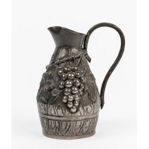 A pewter grape and vine decorated wine ewer, signed to body P.…