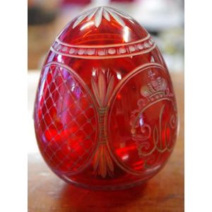 Faberge ruby red glass egg decorated with four cartouches, 9 cm…