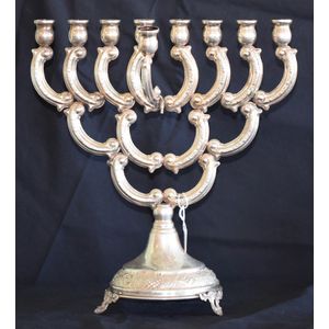 A 800 silver Jewish Menorah, eight aligned candles, and one…