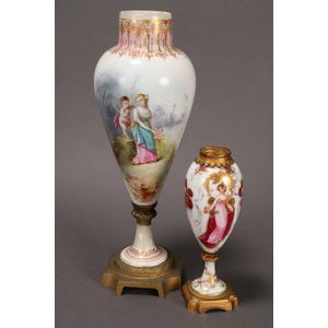 Two Continental porcelain urns on stands, both of tapering form,…