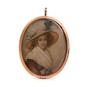 A gold framed portrait miniature of a lady wearing a white…