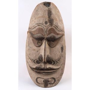 A gable mask, carved wood and shell with earth pigments, Papua…