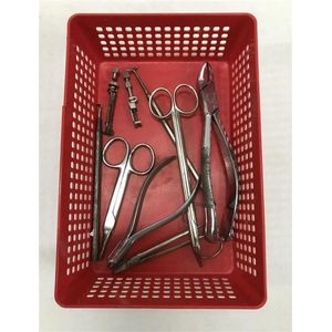 A tray of vintage dental tools, including pliers and clamps