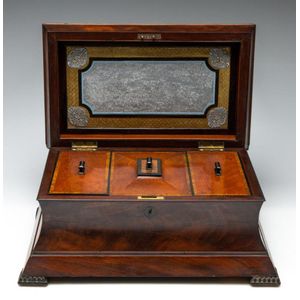 A Regency flame mahogany sarcophagus form tea caddy, height 20…