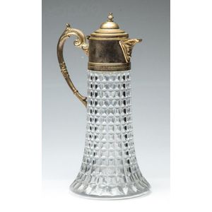 A large silverplated and glass claret jug with etched work,…