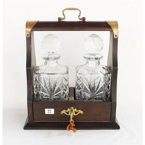 An mahogany tantalus with two crystal decanters key available…