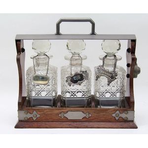 A late 19th century tantalus set with three spirit decanters…