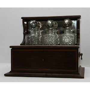 A Sheraton revival rosewood cased three bottle tantalus stand.…