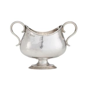 An Arts & Crafts sterling silver sugar bowl, by Omar Ramsden,…