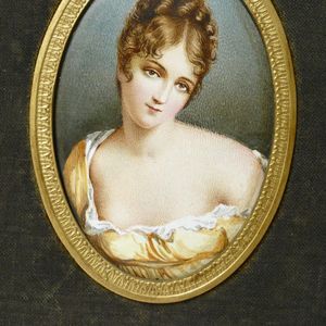 A pair of hand painted enamel portrait miniatures, one of…