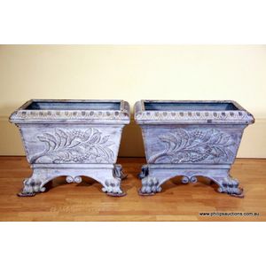 A pair of cast iron decorative planters, the tapering…
