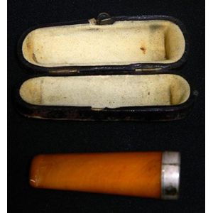 A leather cased amber cigar holder with sterling mount