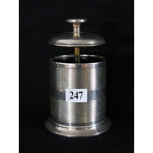 A silver cigarette dispenser, circualr form, machine-turned…