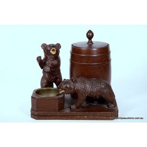 An antique musical Black Forest carved bear cigarette set,…