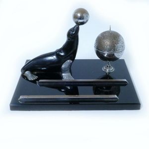 An Art Deco performing seal themed desk set, in lacquered and…