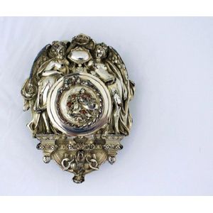 A Victorian plated ink set, the hinged top with chased cherubs…