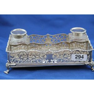 A silver desk set with two silver top bottles, pierced gallery…