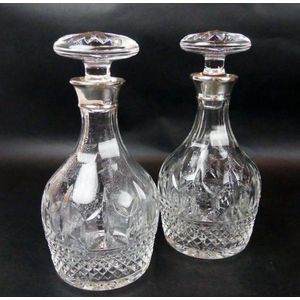 A pair of cut glass decanters each with silver collar,…