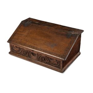 An English writing slope, carved oak with fitted interior,…