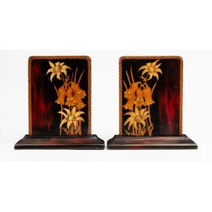 A pair of pokerwork bookends, circa 1930, the face of each…