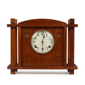An Australian Arts & Crafts cased mantel clock, fiddleback…
