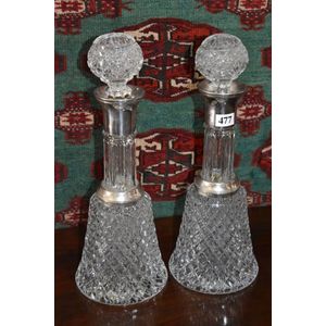 Pair of heavily cut crystal decanters with silver plate collars