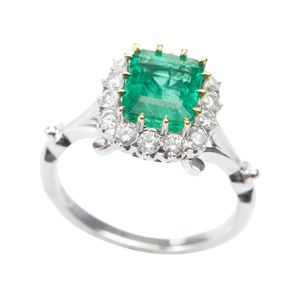 An emerald and diamond ring, featuring an emerald cut emerald…