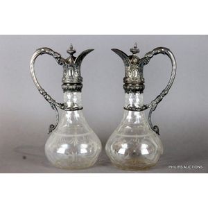 A pair of Victorian silver plate mounted cut glass claret jugs,…