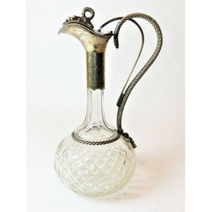Silver plated and glass decanter featuring a rope twisted…