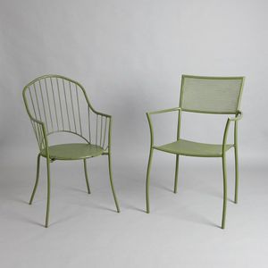 A set of four cast alloy garden chairs, two with arched backs,…