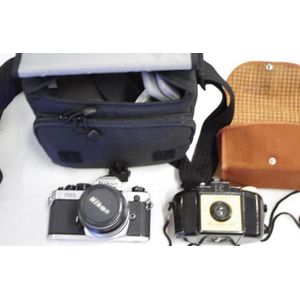 Two vintage cameras, Nikon fm2 and Brownie 127. With cases