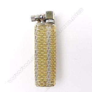 A vintage 18ct. yellow gold outer cased cigarette lighter, the…