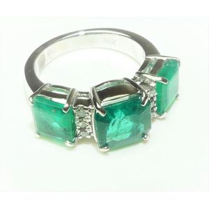 A trio emerald ring with a striking emerald cut centre and…