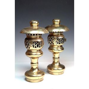 A pair of altar lamps, for oil, a central latticed container…