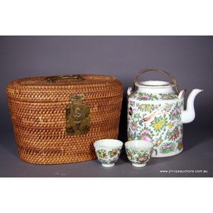 A Chinese rattan tea caddy with a rose medallion teapot and two…