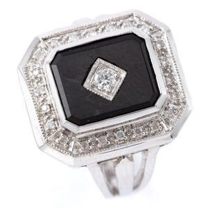 An Art Deco style diamond and onyx ring, emerald shape top with…
